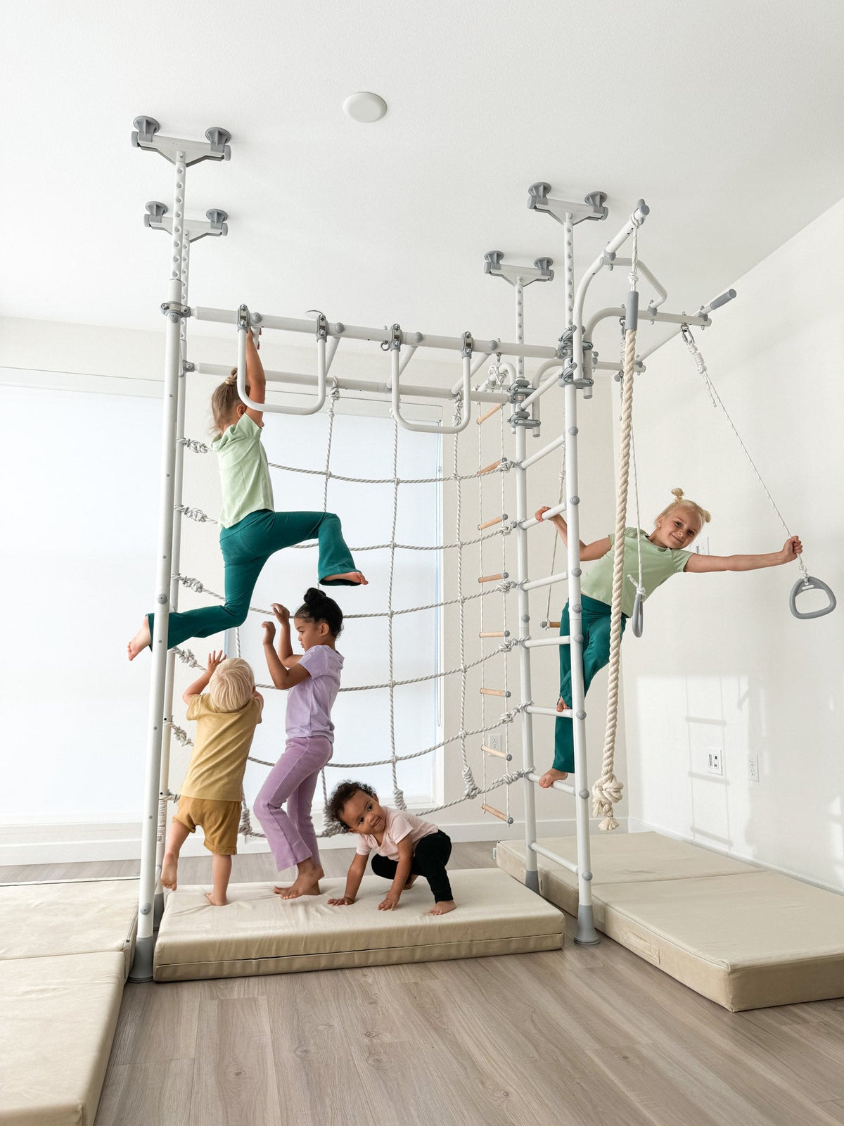 Five kids play together on one Brainrich indoor play gym at home