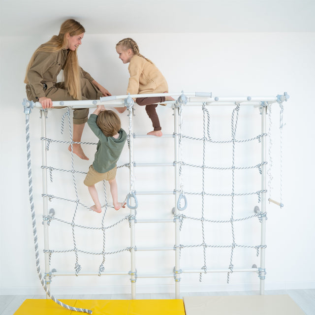 Three kids playing on top of a Brainrich home play gym