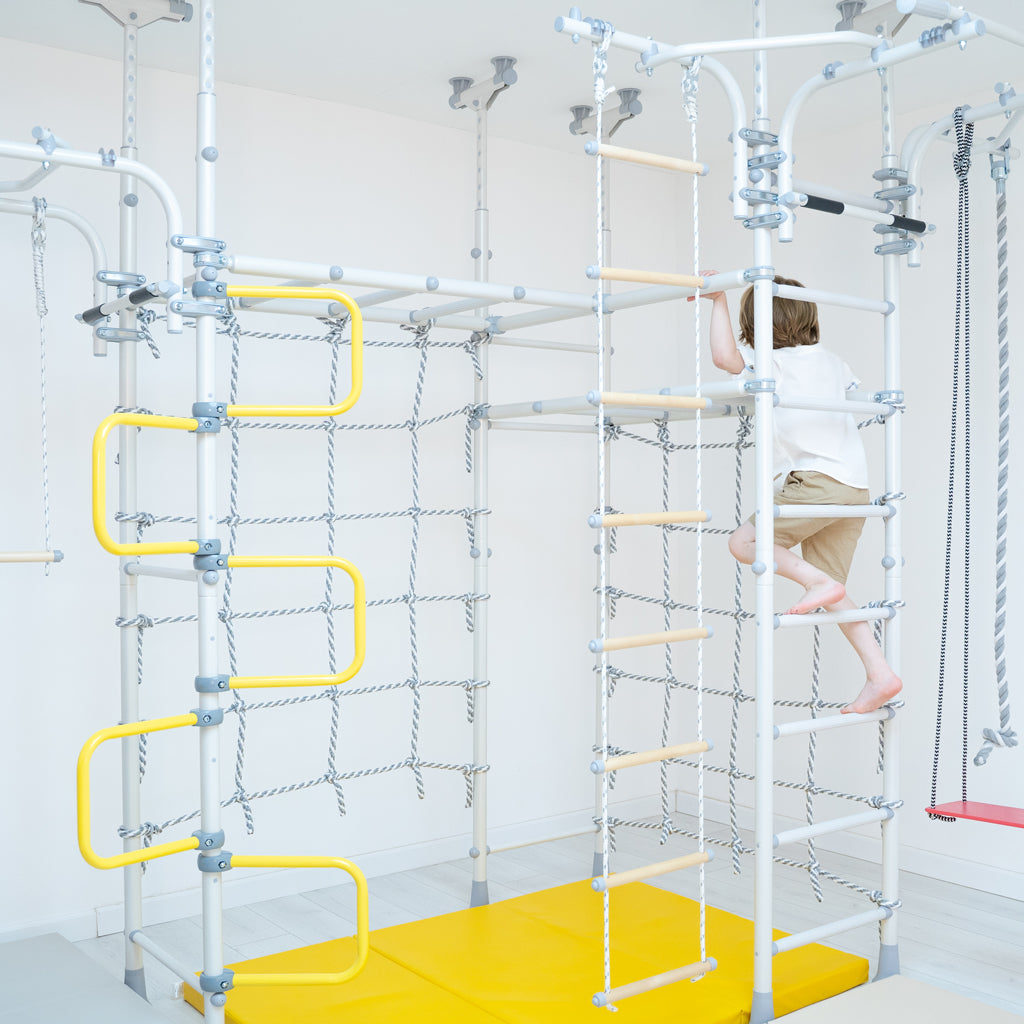 Spider V2 Max from Brainrich Kids. Tension-mounted home play gym for kids. Fully adjustable and modular play set that comes with the rings, trapeze, climbing rope, rope ladder and two rope nets. Ideal for home sensory play room. 